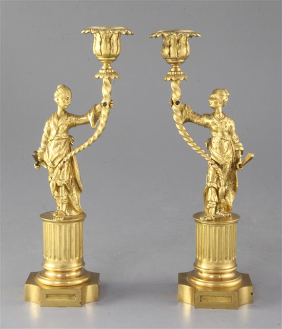 A pair of Regency gilt brass chinoiserie candlesticks, height 9.25in.
